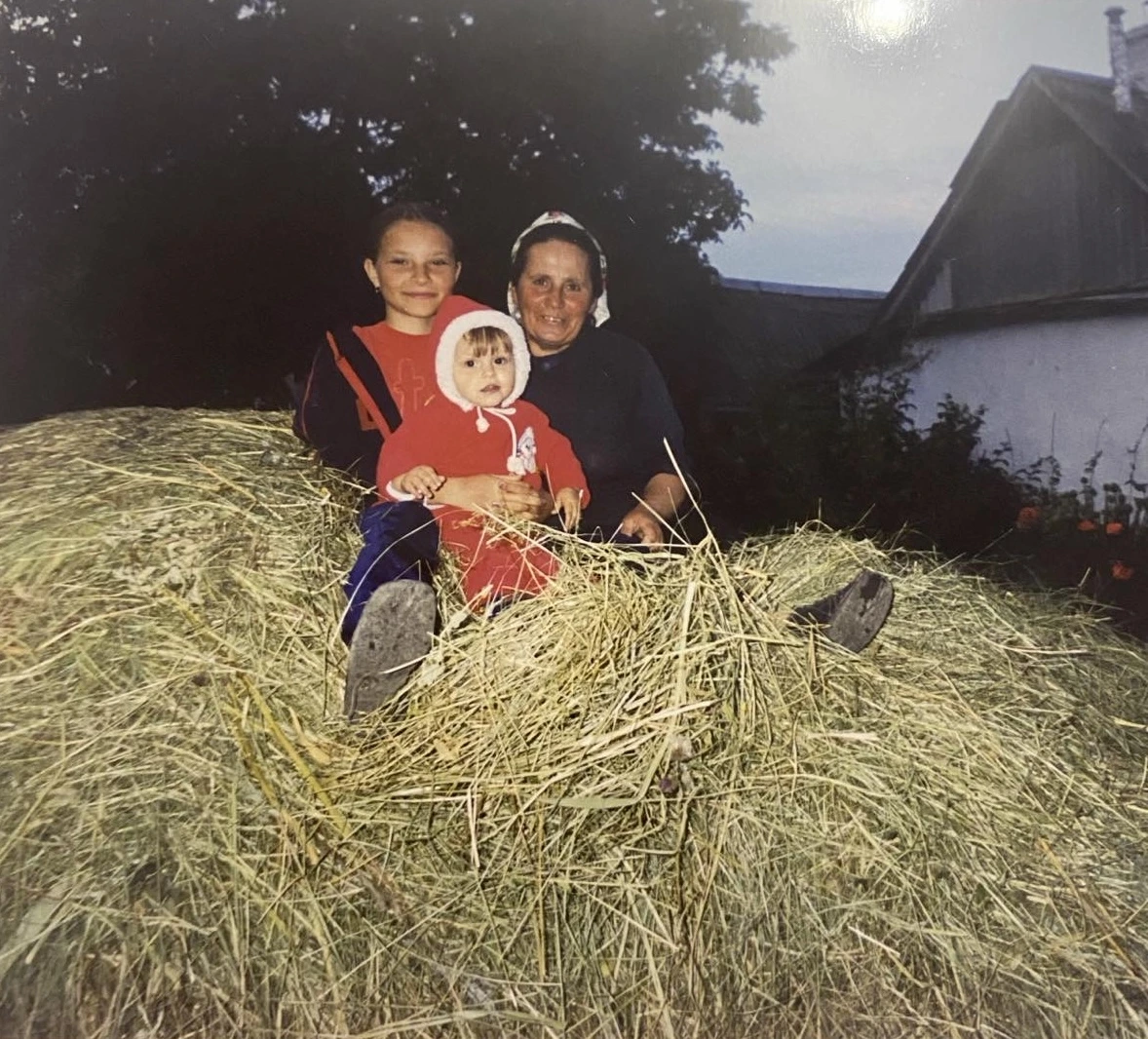 A family sitting together on a pile of hay
